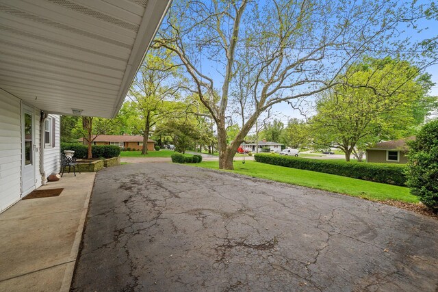 view of patio featuring asphalt driveway