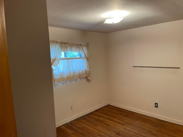 empty room with wood finished floors and baseboards