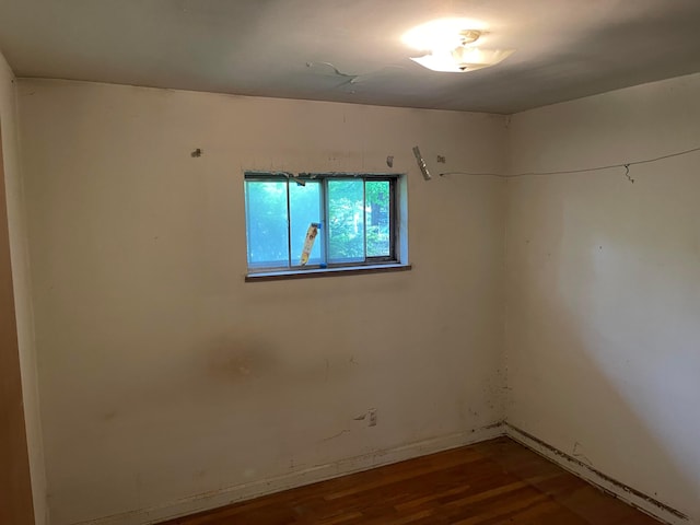 empty room with wood finished floors and baseboards