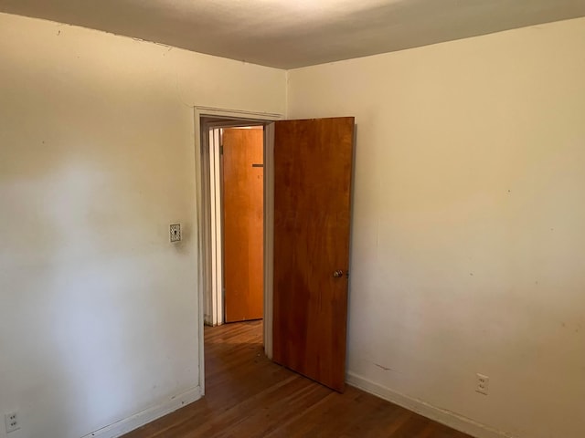unfurnished room with wood finished floors and baseboards