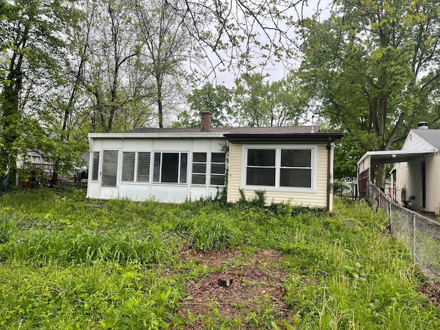 rear view of house with fence