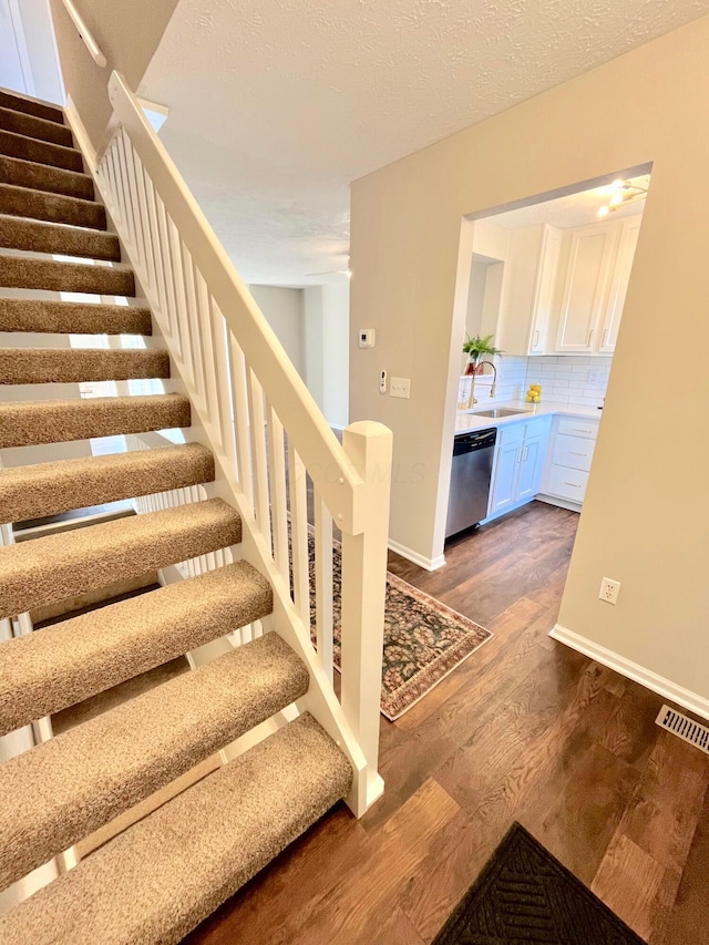 755 Parkbluff Way, Lewis Center, OH 43035 - stairs featuring wood finished floors, baseboards, and a textured ceiling