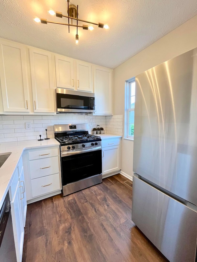 755 Parkbluff Way, Lewis Center, OH 43035 - kitchen featuring stainless steel appliances, dark wood finished floors, white cabinetry, backsplash, and a textured ceiling