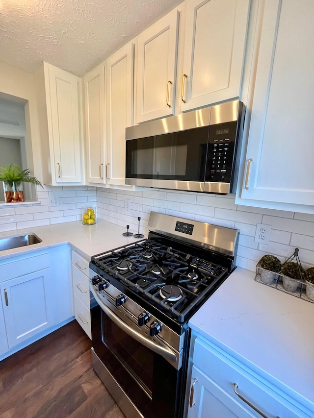 755 Parkbluff Way, Lewis Center, OH 43035 - kitchen featuring stainless steel appliances, light countertops, a sink, white cabinets, and tasteful backsplash