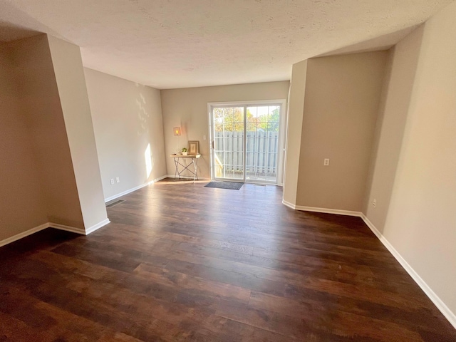 755 Parkbluff Way, Lewis Center, OH 43035 - unfurnished room featuring dark wood finished floors, baseboards, and a textured ceiling