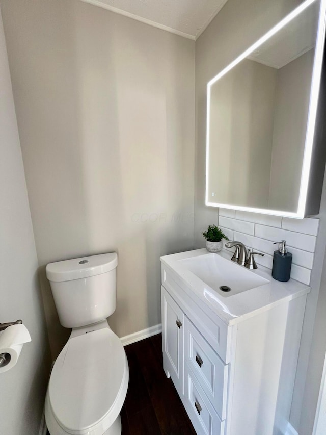 755 Parkbluff Way, Lewis Center, OH 43035 - bathroom featuring vanity, toilet, backsplash, baseboards, and wood finished floors