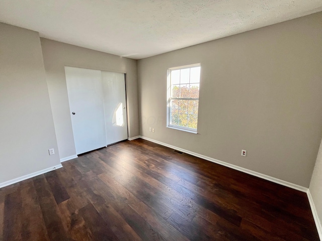 755 Parkbluff Way, Lewis Center, OH 43035 - unfurnished bedroom with dark wood finished floors, baseboards, and a closet