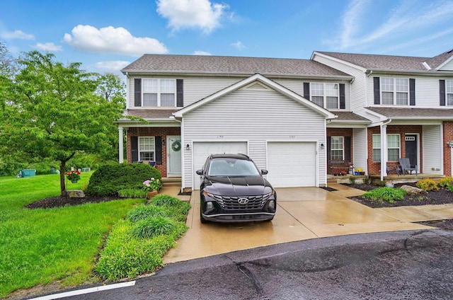 view of front of property featuring a porch, driveway, a front lawn, and brick siding