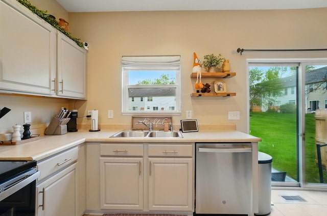 kitchen with dishwasher, a sink, plenty of natural light, and light countertops