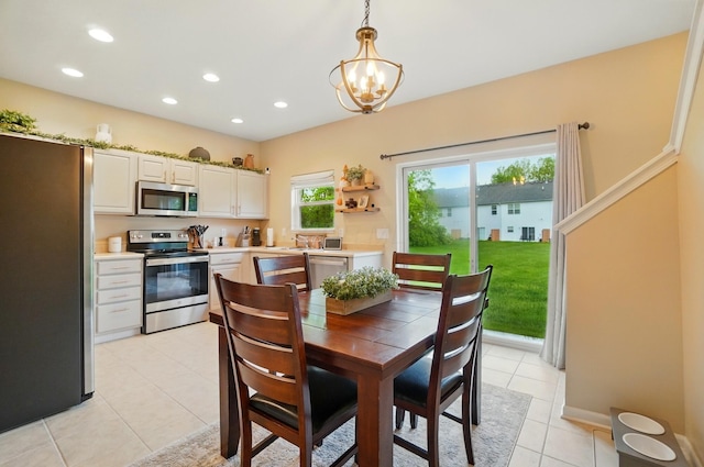 dining area featuring recessed lighting, light tile patterned floors, and a chandelier