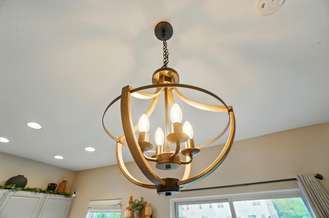 detailed view of a chandelier and recessed lighting