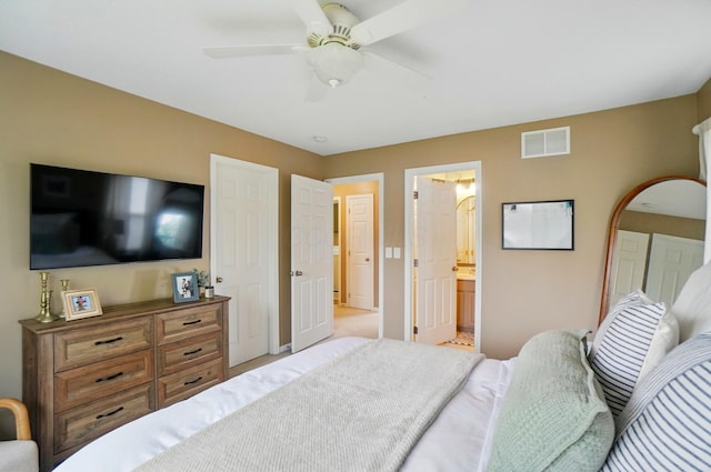 bedroom with ceiling fan, baseboards, and connected bathroom