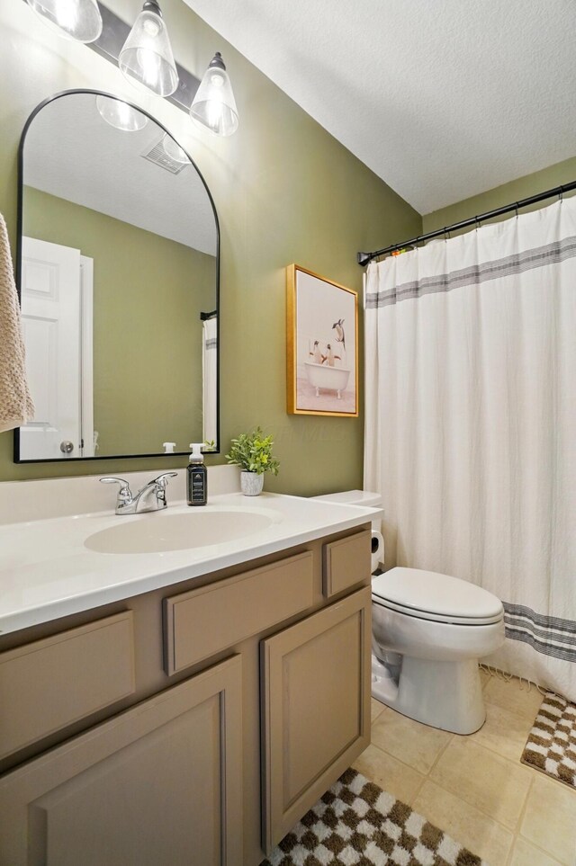 full bathroom with vanity, toilet, and tile patterned floors