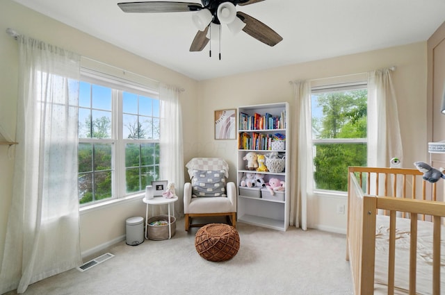 sitting room featuring healthy amount of natural light and light colored carpet