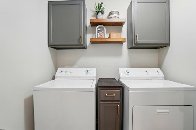 laundry area with washer and dryer and cabinet space