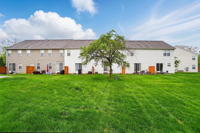 rear view of property with a yard