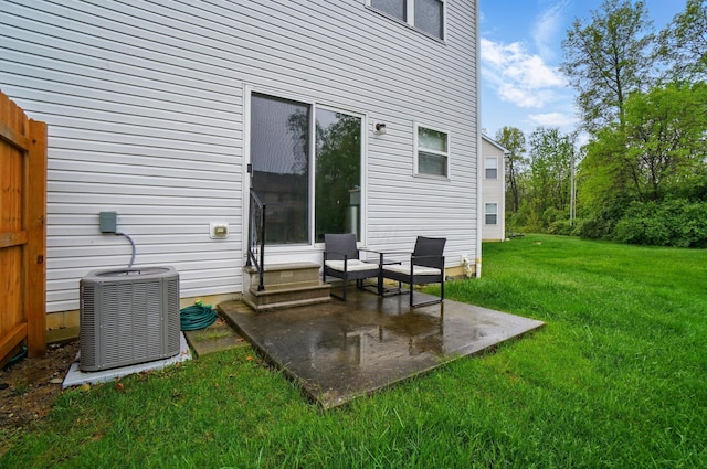 back of house with central AC, a patio, and a yard