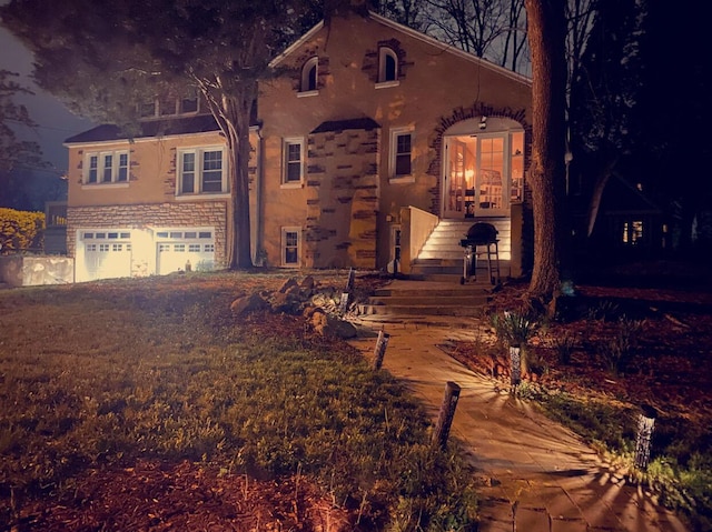 1065 Sunbury Rd, Columbus, OH 43219 - view of front of home with a garage and stucco siding