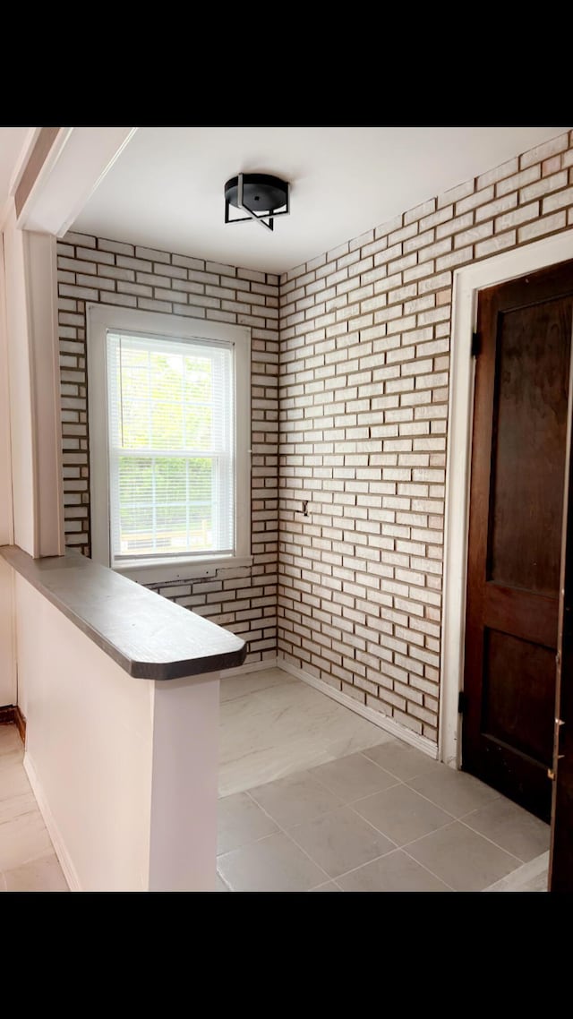1065 Sunbury Rd, Columbus, OH 43219 - bathroom featuring brick wall