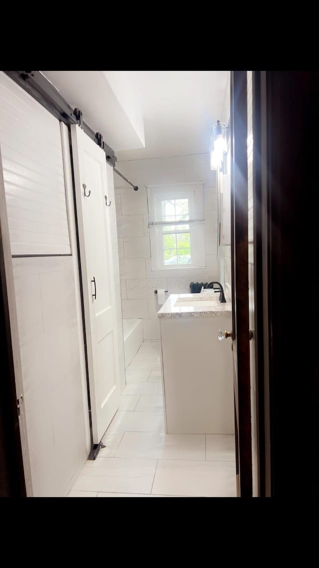 1065 Sunbury Rd, Columbus, OH 43219 - bathroom with vanity, washtub / shower combination, and tile patterned flooring