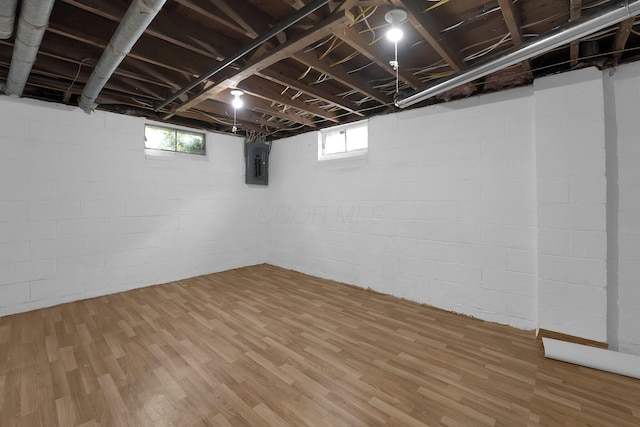 basement with electric panel and wood finished floors