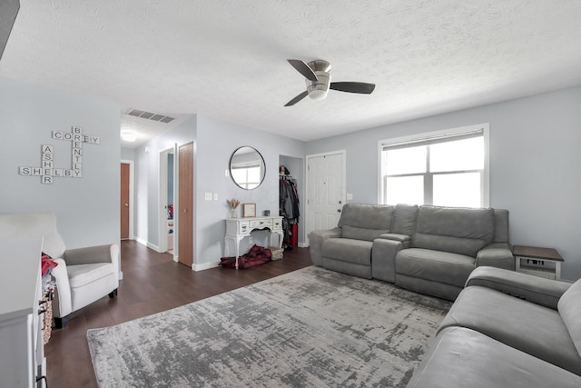 509 Section Line Dr, South Charleston, OH 45368 - living area with ceiling fan, dark wood finished floors, a textured ceiling, and baseboards