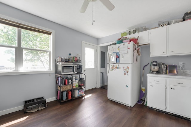 509 Section Line Dr, South Charleston, OH 45368 - kitchen featuring freestanding refrigerator, stainless steel microwave, light countertops, white cabinetry, and dark wood-style flooring