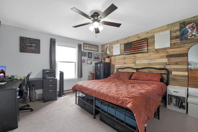 509 Section Line Dr, South Charleston, OH 45368 - carpeted bedroom with an office area, wooden walls, a ceiling fan, and a baseboard radiator