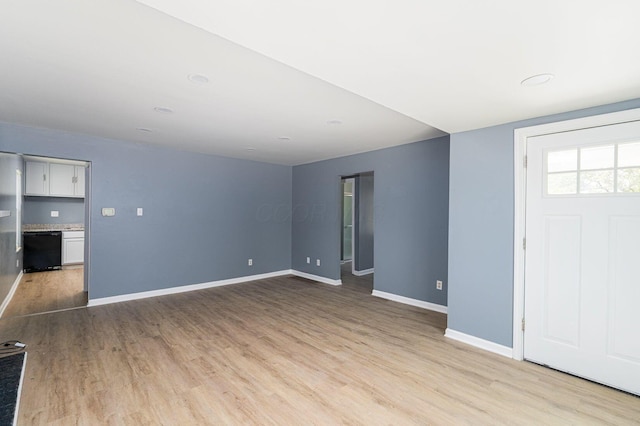 foyer with light wood finished floors and baseboards