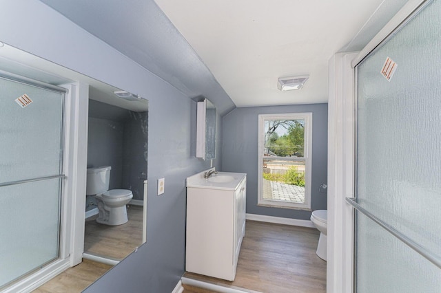 laundry area featuring light wood finished floors, a sink, and baseboards