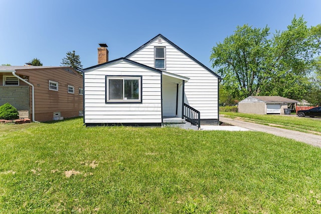 view of front facade with a chimney and a front yard