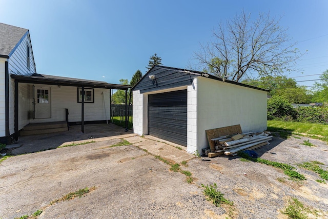 detached garage with asphalt driveway