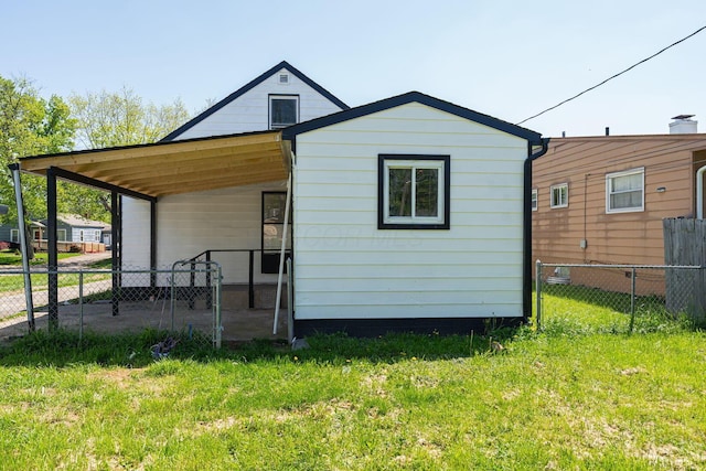 back of property with a carport