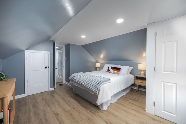 1828 Ferris Rd, Columbus, OH 43224 - bedroom featuring light wood-style flooring, vaulted ceiling, and recessed lighting