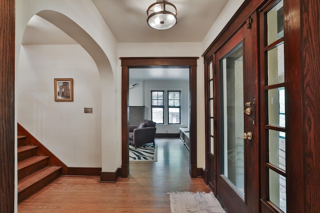 2663 Glen Echo Dr, Columbus, OH 43202 - corridor featuring baseboards, arched walkways, wood finished floors, and stairway