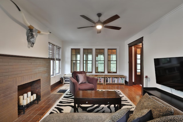 2663 Glen Echo Dr, Columbus, OH 43202 - living room featuring ceiling fan, a brick fireplace, wood finished floors, and ornamental molding