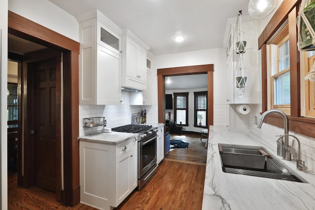 2663 Glen Echo Dr, Columbus, OH 43202 - kitchen with stainless steel range, a sink, white cabinetry, tasteful backsplash, and light stone counters