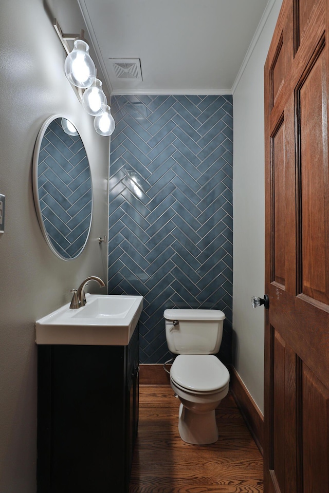 2663 Glen Echo Dr, Columbus, OH 43202 - half bath featuring ornamental molding, toilet, vanity, and wood finished floors