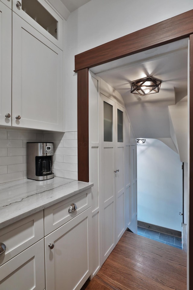2663 Glen Echo Dr, Columbus, OH 43202 - kitchen with lofted ceiling, tasteful backsplash, white cabinets, glass insert cabinets, and light stone counters