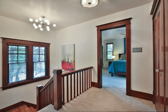 2663 Glen Echo Dr, Columbus, OH 43202 - hall featuring an upstairs landing, baseboards, carpet floors, and a chandelier