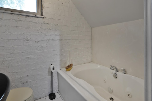 2663 Glen Echo Dr, Columbus, OH 43202 - bathroom with vaulted ceiling, a whirlpool tub, tile patterned flooring, and toilet