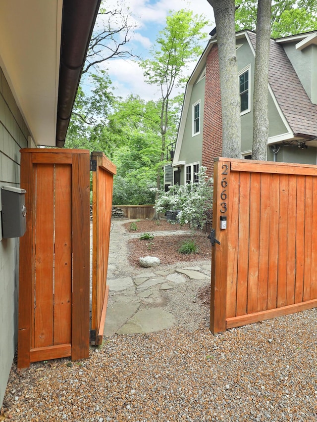 2663 Glen Echo Dr, Columbus, OH 43202 - view of property exterior with roof with shingles, a gate, fence, and a chimney