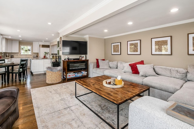 living room with dark wood finished floors, recessed lighting, and ornamental molding