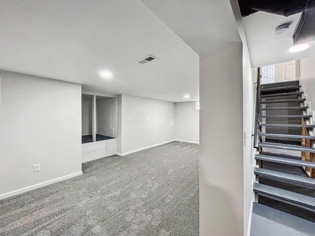 finished below grade area with stairs, carpet flooring, recessed lighting, and baseboards
