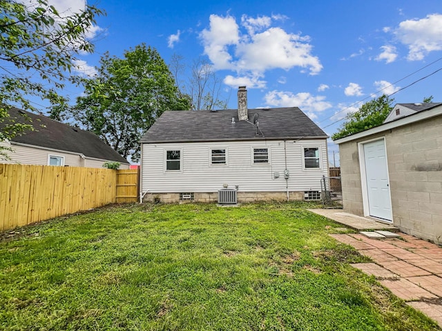 rear view of property with cooling unit and a chimney