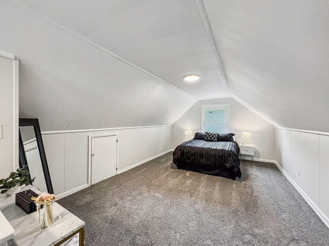 bedroom with lofted ceiling, carpet, and baseboards
