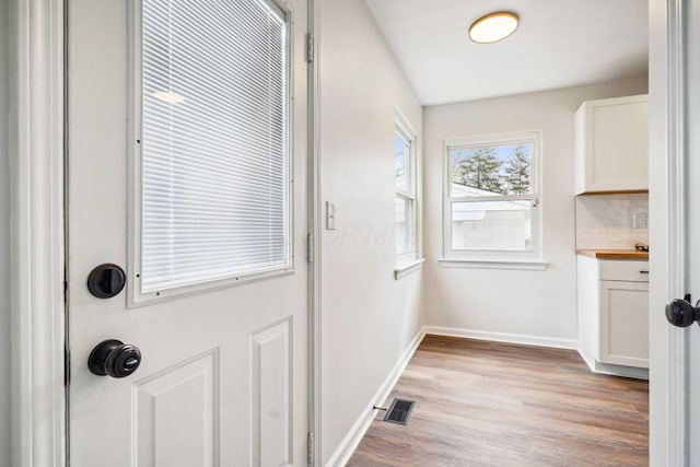 3476 Beulah Rd, Columbus, OH 43224 - doorway to outside featuring light wood finished floors and baseboards