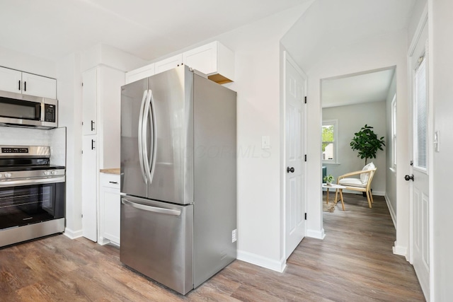 3476 Beulah Rd, Columbus, OH 43224 - kitchen featuring appliances with stainless steel finishes, wood finished floors, white cabinets, and baseboards