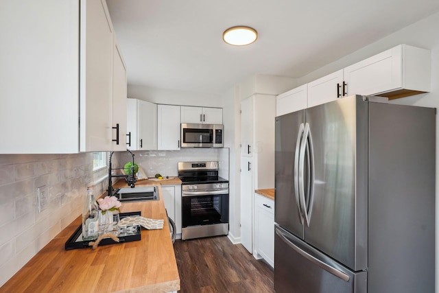 3476 Beulah Rd, Columbus, OH 43224 - kitchen with appliances with stainless steel finishes, wood counters, a sink, and white cabinetry
