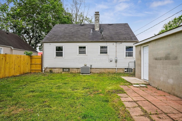 3476 Beulah Rd, Columbus, OH 43224 - back of house featuring central AC unit, a chimney, and a shingled roof